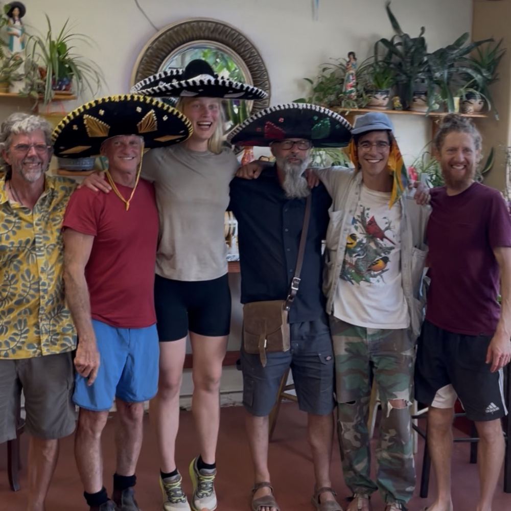A group of hikers in sombreros inside the store