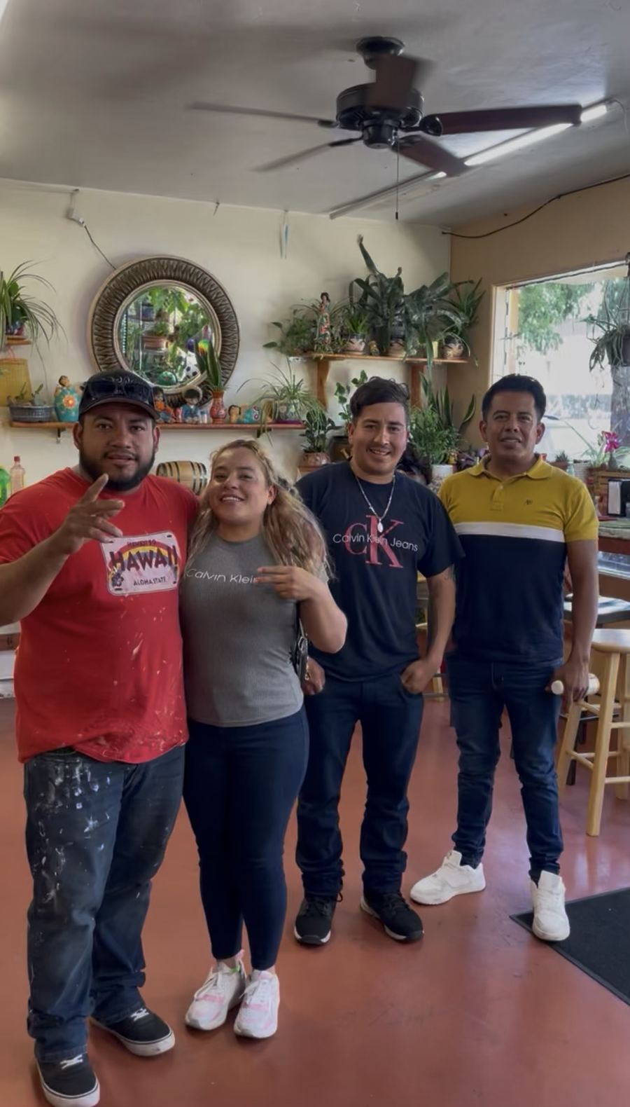 Four customers smiling inside the store