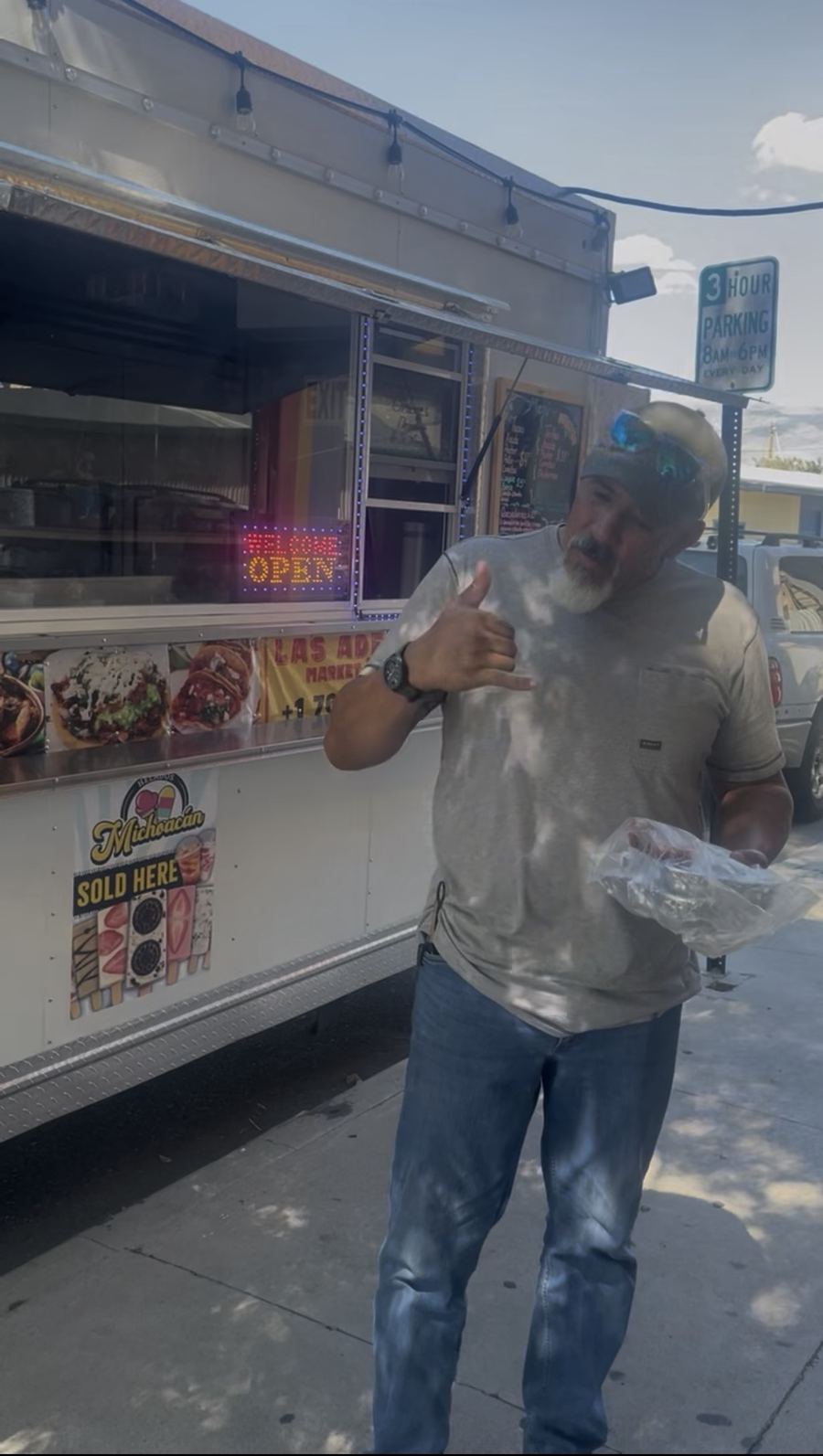A happy customer by the truck with his order