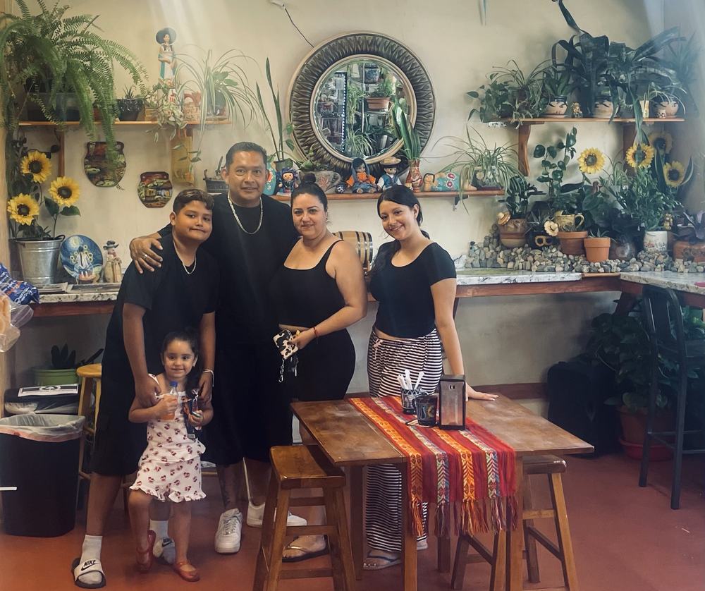 A family posing together in the dining room