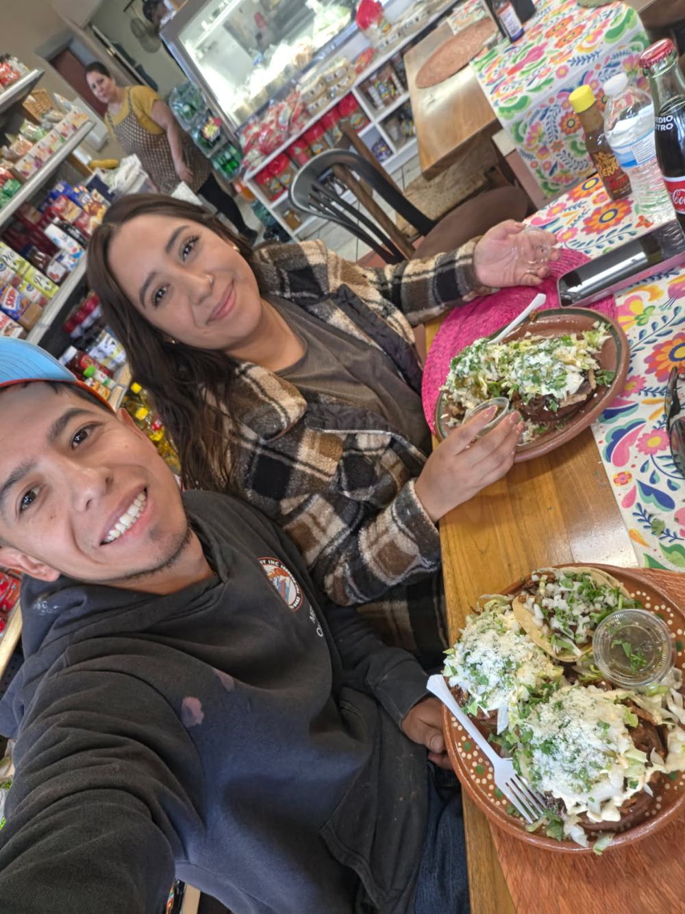 A couple taking a selfie with their plates