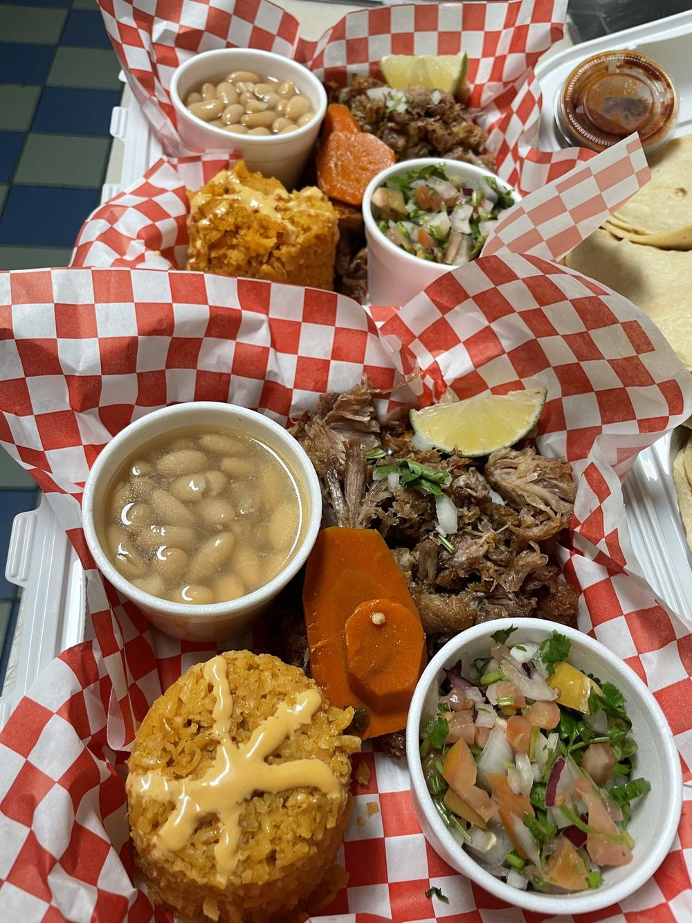 Carnitas orders with rice, beans, pico de gallo and pickled carrots